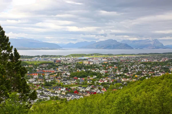 View over the cityscape of Bodo, Norway. Houses in the foreground & the sea & mountains in the background, Scandinavia. Bodo is a municipality in Nordland county, Norway. It is part of the traditional region of Salten.
