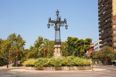 One of the citys emblems is this intricately designed street lamp called La Farola. It was created in 1929 and is surrounded by the few remaining modernist style buildings in the city of Castellon, Valencia, Spain. clipart