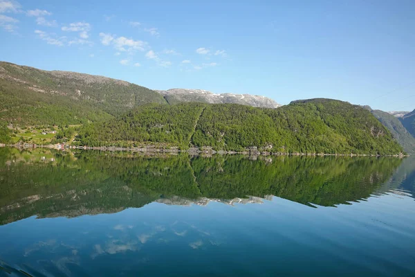 Beautiful landscape in the fjord, with reflections of the mountains in the water. Peace & tranquility, Rosendal, Hardangerfjord, Norway.