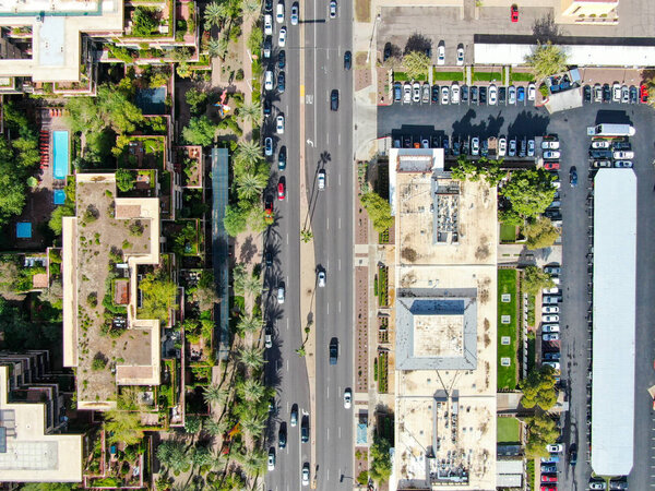 Aerial to view of road and building in Scottsdale desert city in Arizona east of state capital Phoenix. Downtowns Old Town Scottsdale