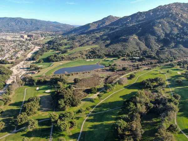Aerial view of golf course with green field in the valley. — Stock Photo, Image