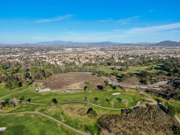 Aerial view of golf course with green field in the valley. — Stock Photo, Image