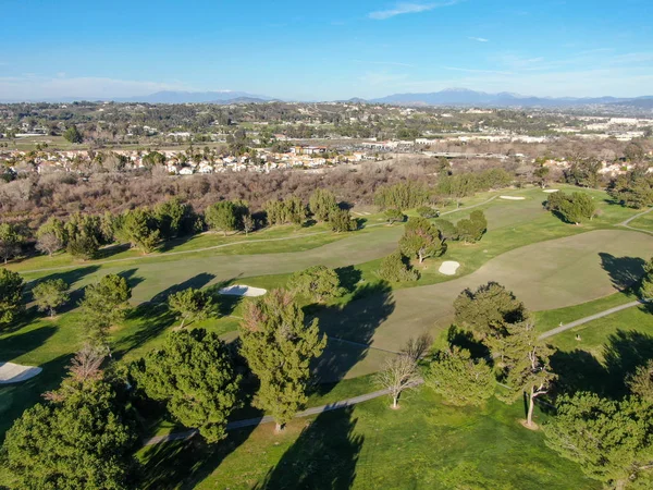 Aerial view of golf course with green field in the valley. — Stock Photo, Image