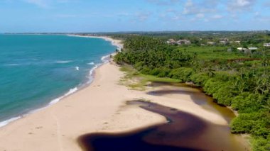 Aerial top view of river merging to tropical white sand beach and turquoise clear ocean