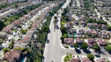 Aerial view of road in typical suburban neighborhood with big villas next to each other, San Diego