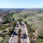 Curving road and downhill with houses in suburb of San Diego