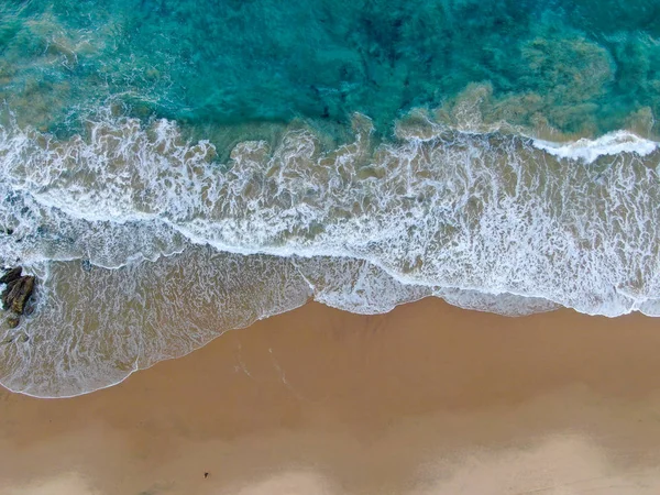 Aerial top view of the ocean waves washing on the coast of the Pacific ocean — 스톡 사진