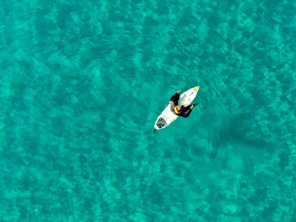 Vue aérienne des surfeurs attendant, pagayant et profitant des vagues dans une belle eau bleue — Photo