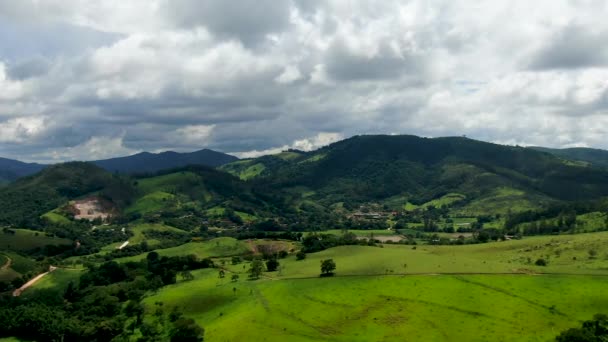 Aerial view of green tropical mountain and small valley during clouded day — Stock Video