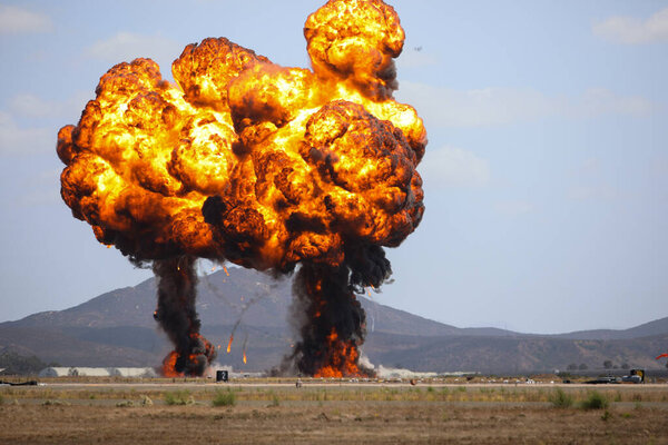 Giant outdoors explosion with fire and black smoke