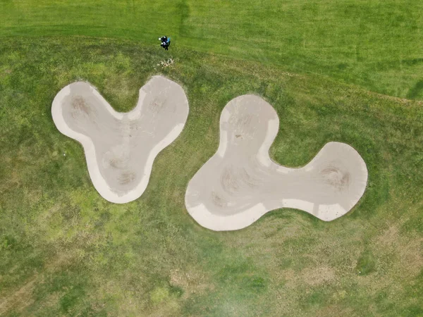 Aerial top view of a green golf course during sunny day — Stock Photo, Image