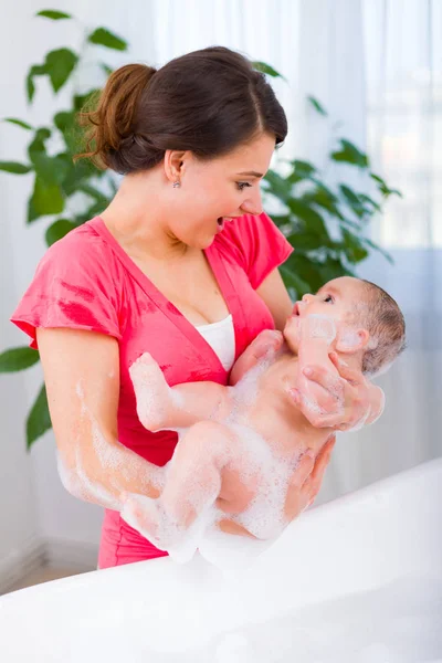 Beautiful mother cleaning baby — Stock Photo, Image