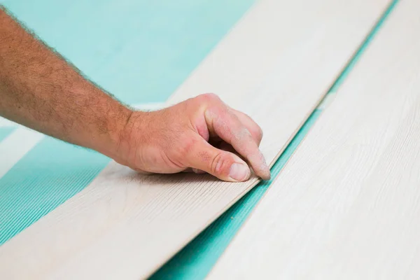 Installing laminate floor with wooden texture — Stock Photo, Image