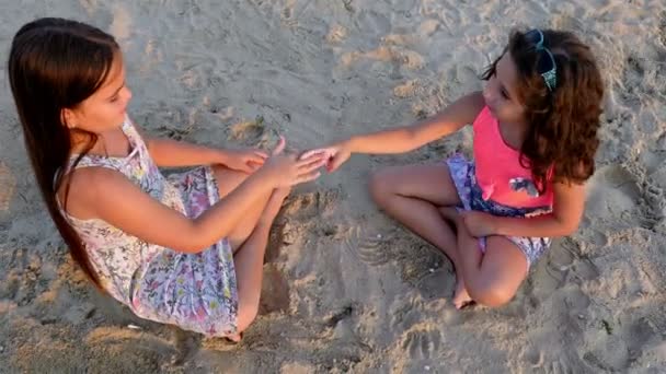Duas meninas brincando na praia do mar — Vídeo de Stock