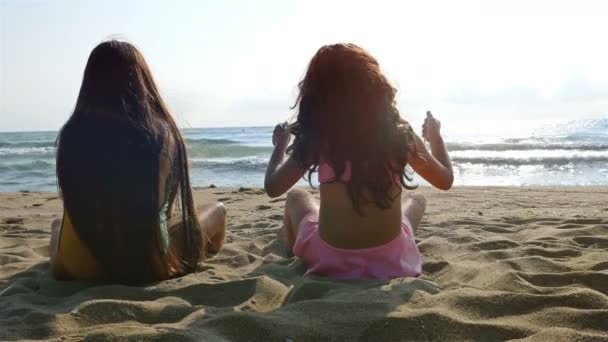 大海沙滩上玩耍的两个小女孩 — 图库视频影像