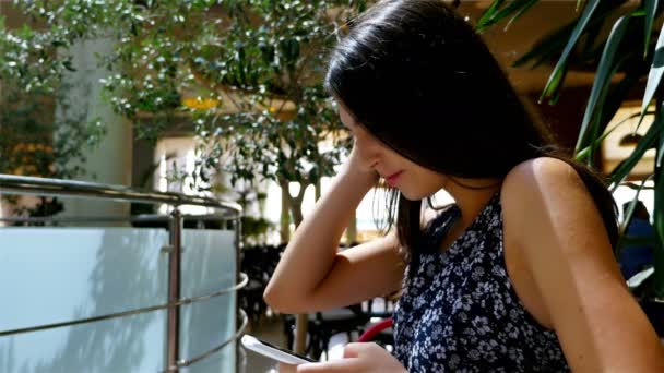 Woman using smart phone in a cafe — Stock Video