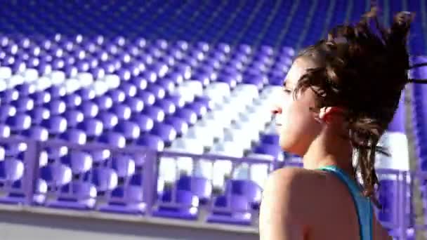 Tracking camera of a track runner athlete woman girl running at a stadium — Αρχείο Βίντεο