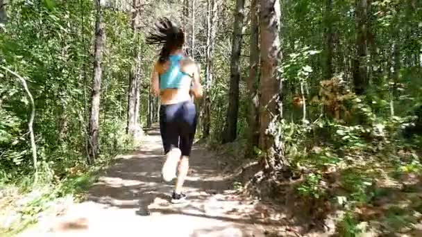 Камера наблюдения за девушкой, бегущей бегом в парке, лесу, лесу, замедленной съемкой — стоковое видео