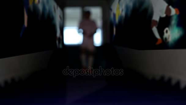 Silhouette of a football player getting out from a tunnel of a stadium — Stock Video