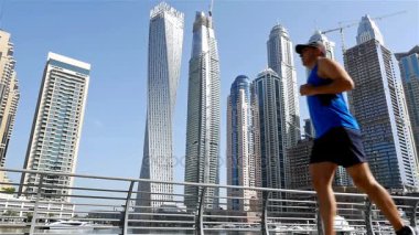 Dubai Yat Limanı içinde sabah yavaş Koşu koşan atletik fitness adam düşük açılı görünümü