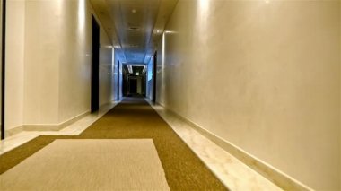 Bir otel uzun hafif bir koridorda yürürken