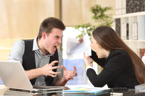 Two angry businesspeople arguing furious