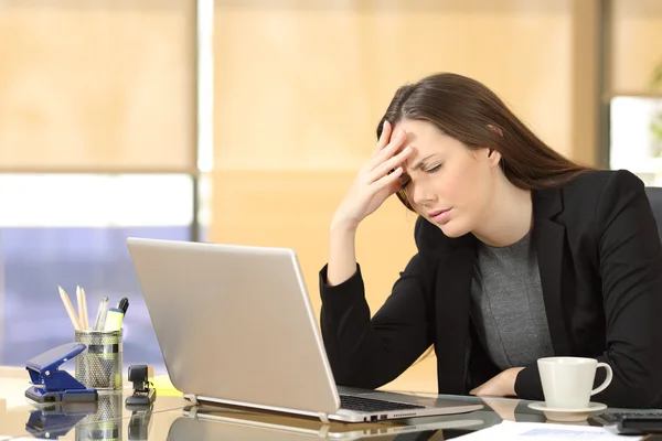 Businesswoman suffering migraines at work