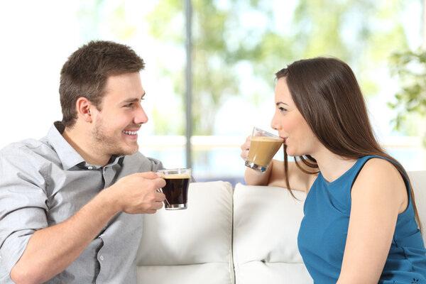 Couple talking and drinking coffee