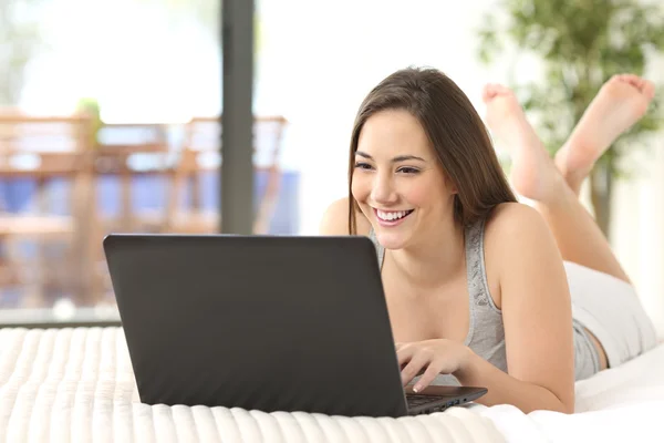 Щасливий підліток переглядає ноутбук онлайн вдома — стокове фото