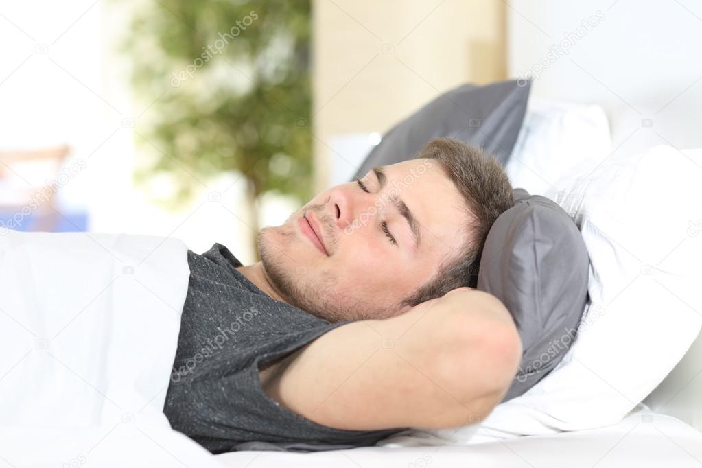 Man sleeping on a comfortable bed 