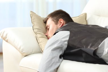 Tired businessman sleeping after work clipart