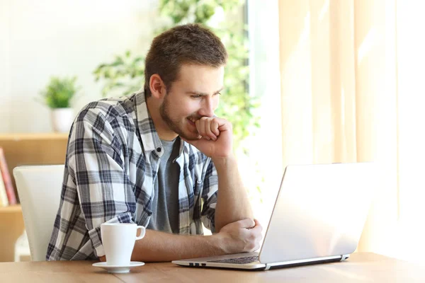Man watching media in a laptop at home — Stock Photo, Image
