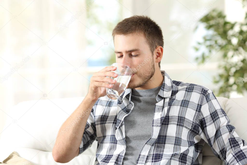Man drinking water at home