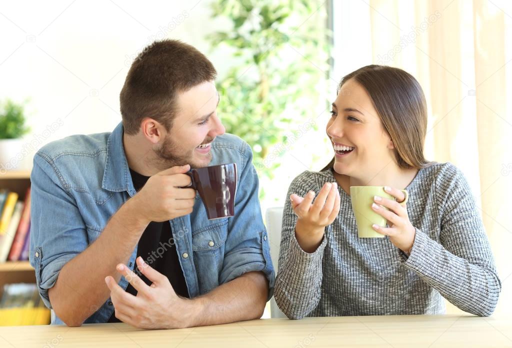 Couple talking during breakfast at home