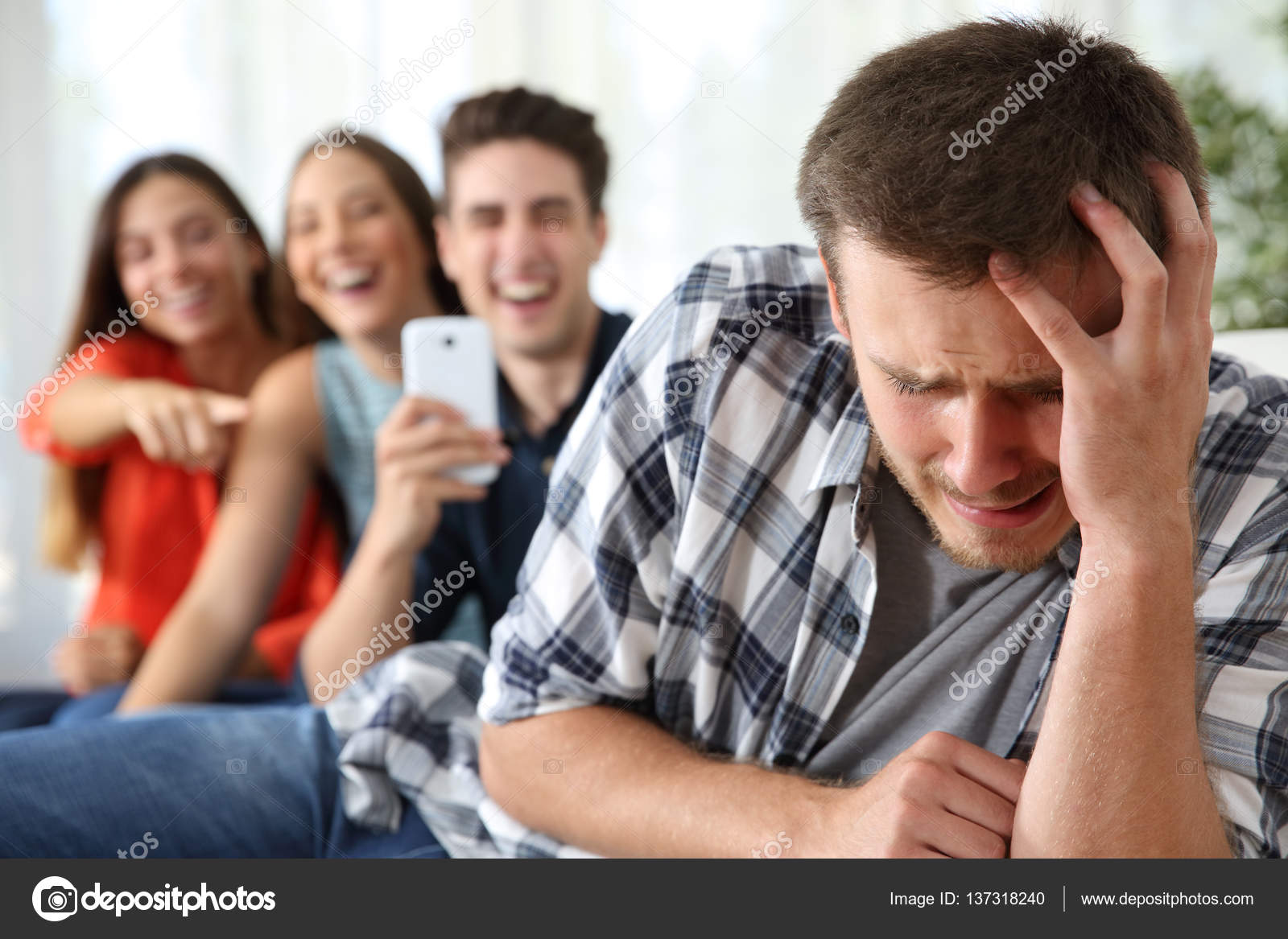Friends Bullying To A Sad Boy Stock Photo C Antonioguillemf