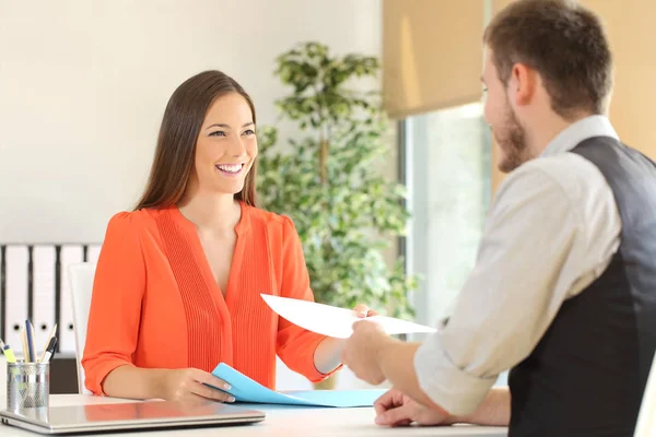 Woman giving resume in a job interview — Stock Photo, Image