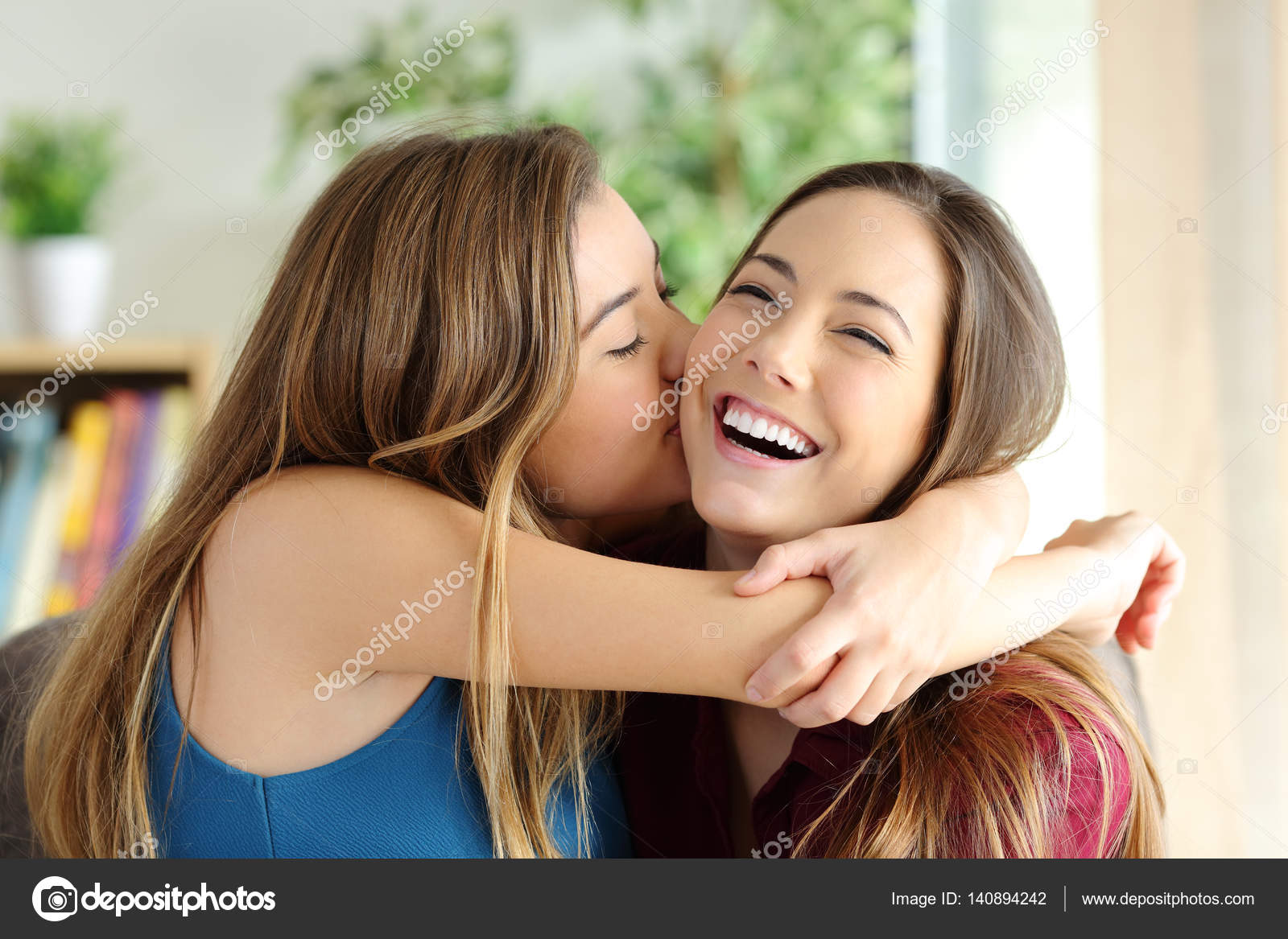 Affectionate girl kissing her sister or friend Stock Photo by ...
