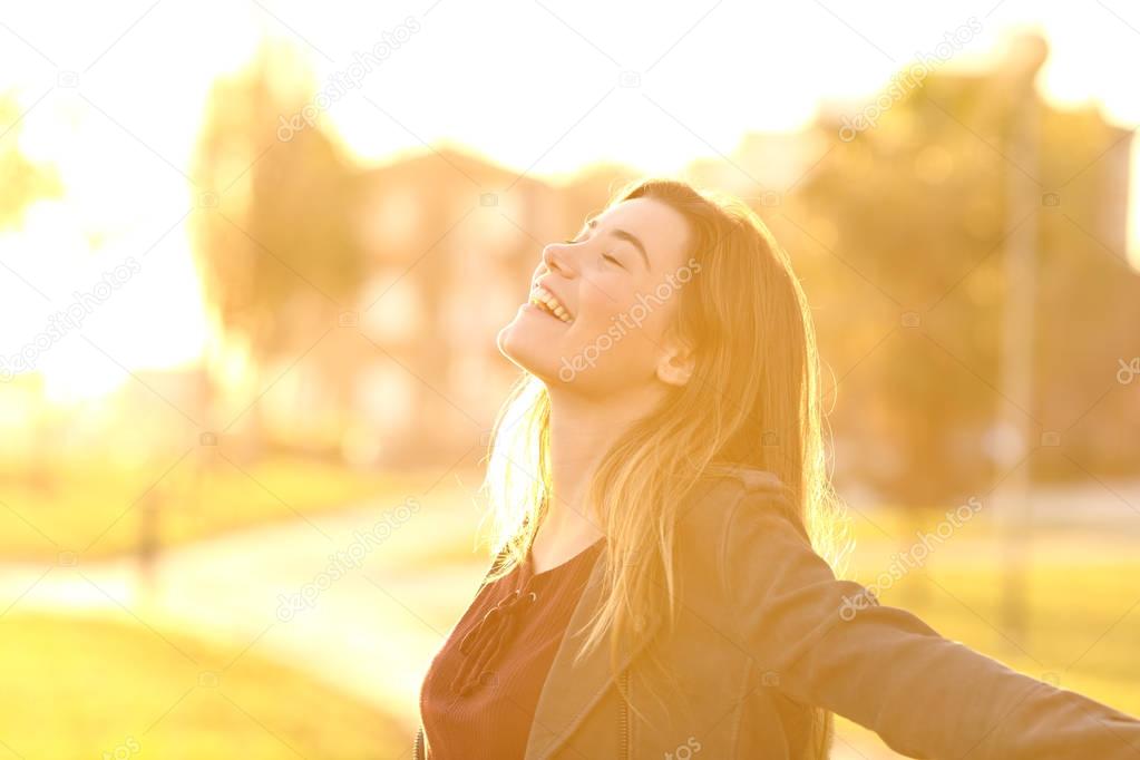 Teen breathing at sunset in a park