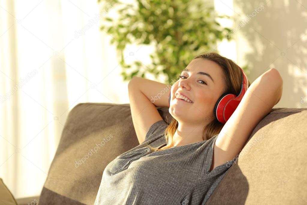 Teen relaxing and listening music at home