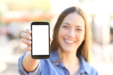 Girl showing a blank smart phone display clipart