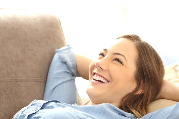 Woman relaxed lying on a couch — Stock Photo, Image
