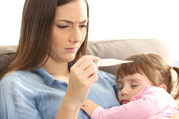 Mother checking thermometer with her ill baby — Stock Photo, Image