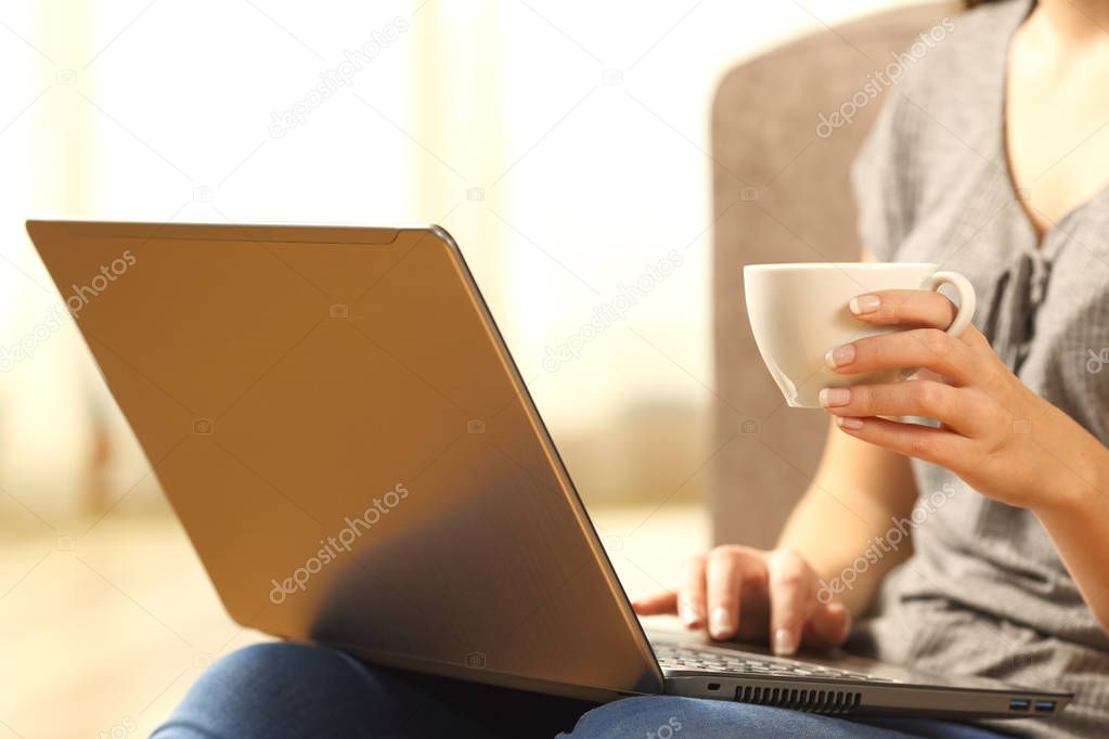 Woman relaxing with a laptop and coffee cup