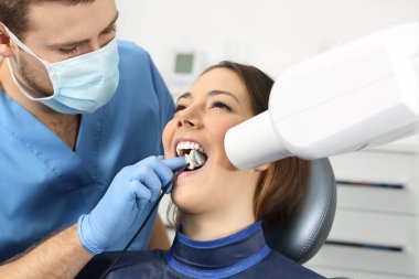 Dentist taking a teeth radiography clipart