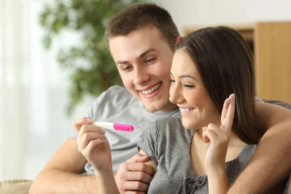 Hopeful couple checking a pregnancy test — Stock Photo, Image