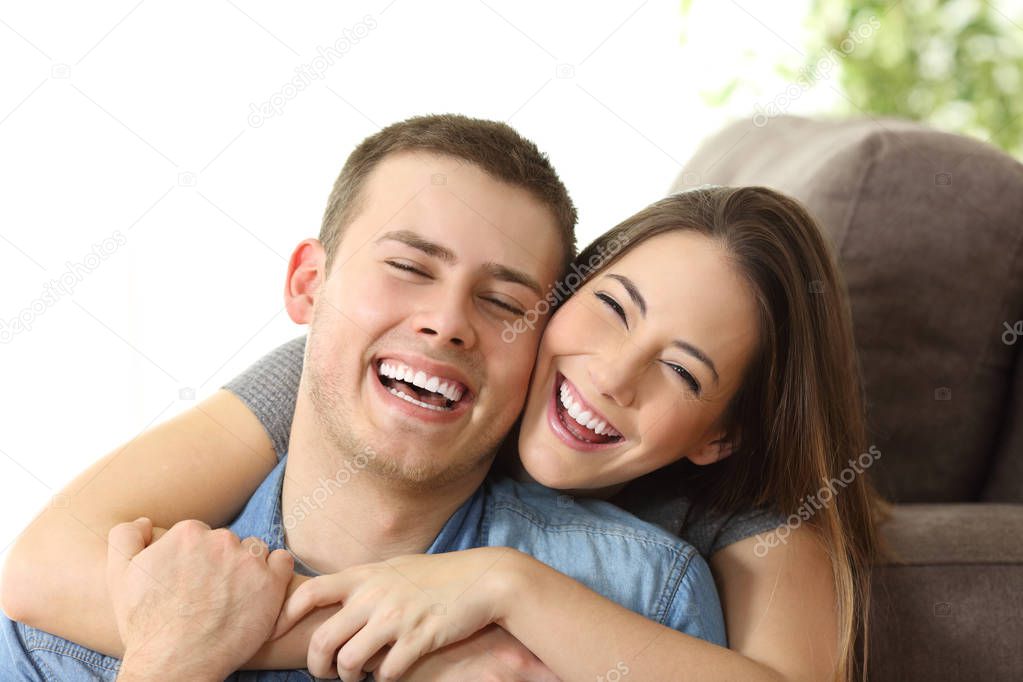 Happy couple with white smile at home