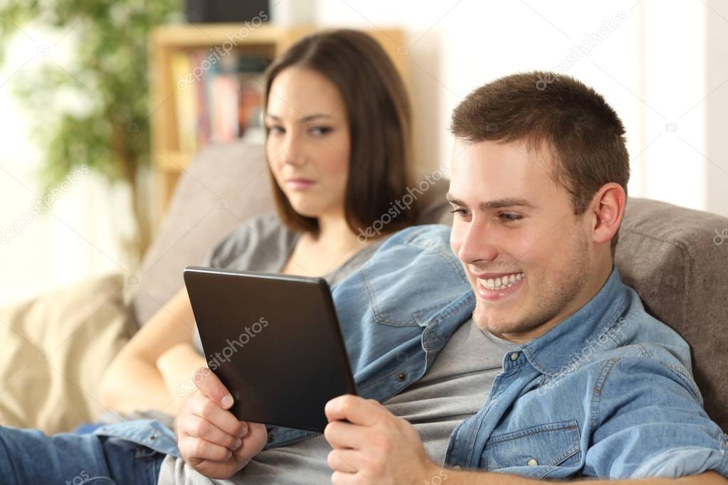 Husband watching online content and ignoring his wife