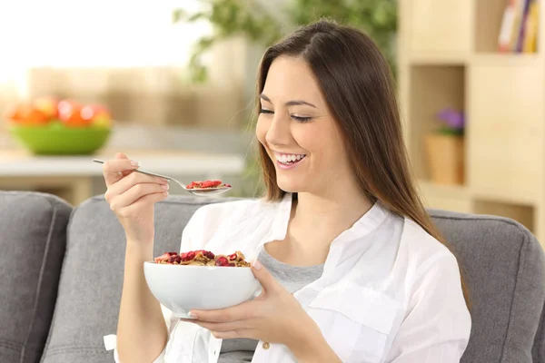 Mulher alegre comendo cereais em casa — Fotografia de Stock