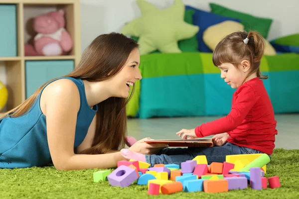 Mamma och barn leker med en bok — Stockfoto