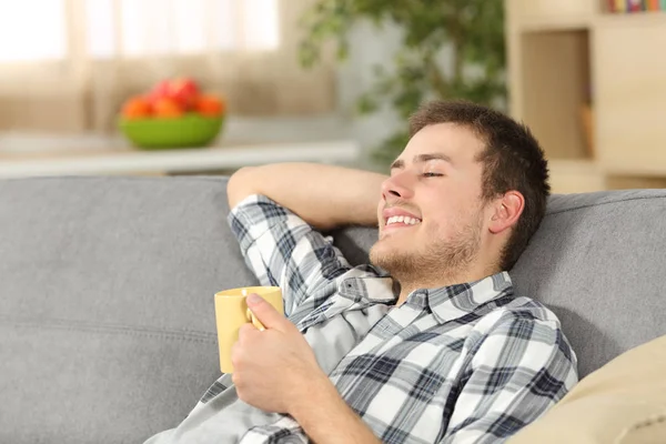 Relaxed man holding a coffee cup at home — Stock Photo, Image